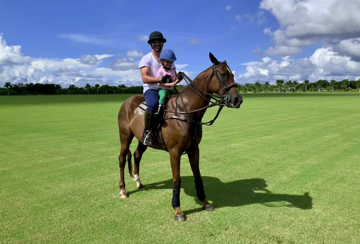 Breanden Beneschott playing polo with his daughter
