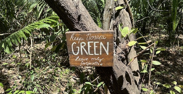 Sign on a walking trail in Nosara, Costa Rica that reads "Keep Nosara Green. Leave Only Footprints"
